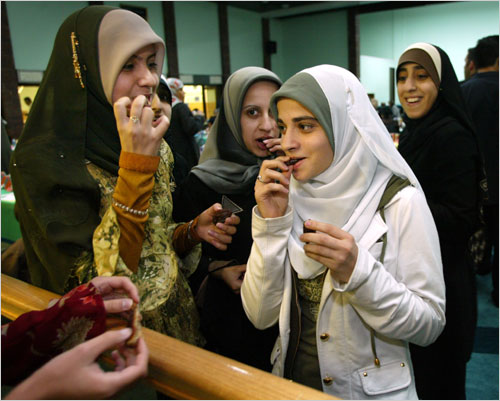 A group of Muslim women eating chocolate