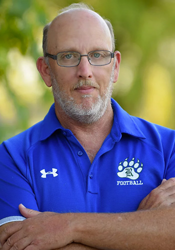 Martin Davis in a blue polo shirt with arms folded