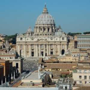 Photo of St. Peter's Basilica in Rome against a blue-gray sky.