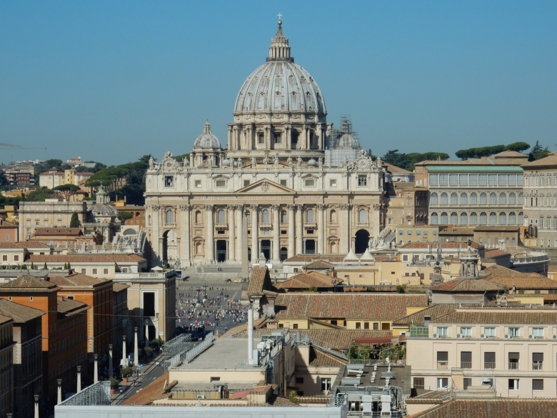 Photo of St. Peter's Basilica in Rome against a blue-gray sky.